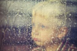 sad boy watching rain
